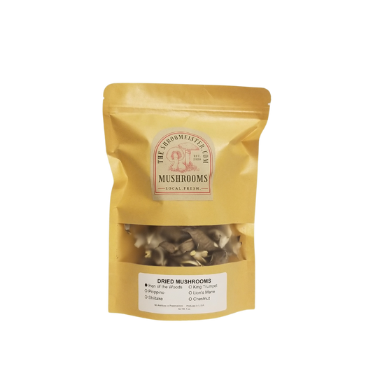 A package of dried Hen of The Woods mushrooms in a gold-colored resealable bag with a clear window showing the product inside.