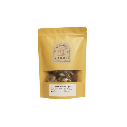 Packaged dried shiitake mushrooms branded as The Shroomeister, in a yellow resealable craft paper bag with a clear window showing the mushrooms inside.