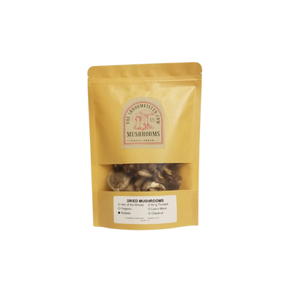 Packaged dried shiitake mushrooms branded as The Shroomeister, in a yellow resealable craft paper bag with a clear window showing the mushrooms inside.